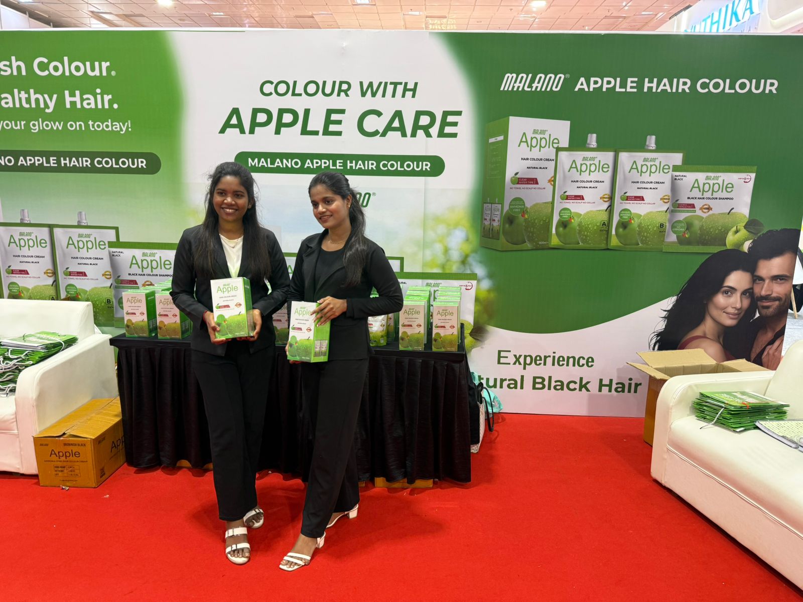 PRIIS exhibition booth team presenting Malano Apple hair colour products at trade fair stand