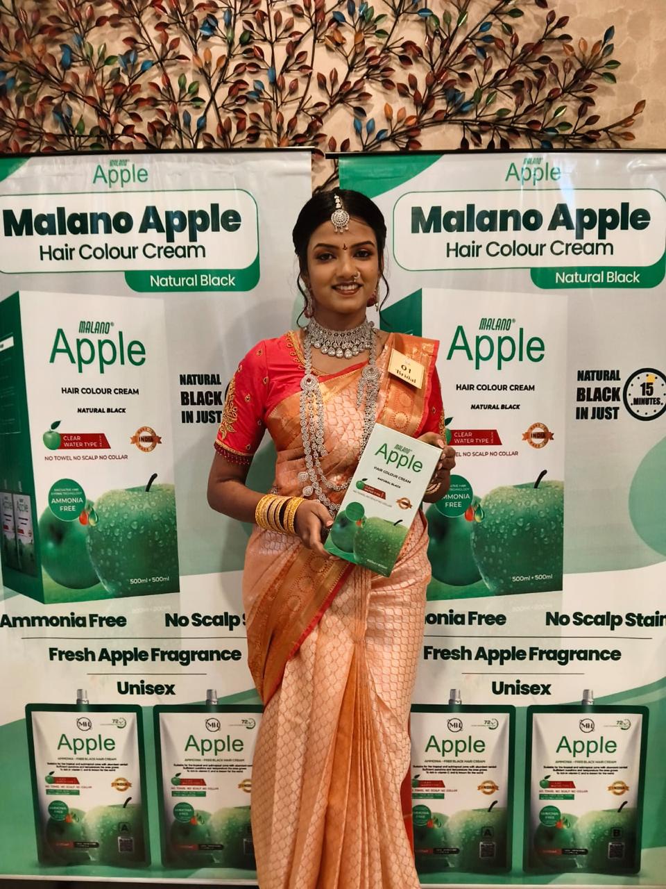 Exhibition participant presenting Malano Apple hair colour cream packaging at the PRIIS booth