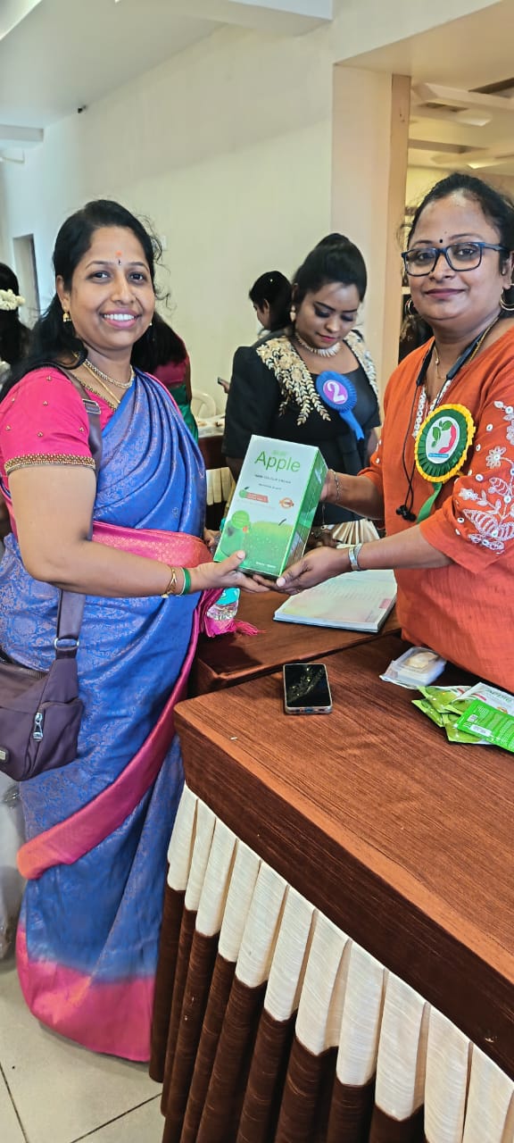 Exhibition handover moment with Malano Apple hair colour product between participants