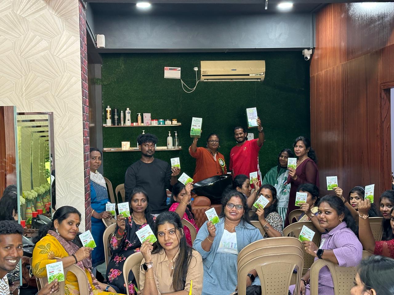 Salon or training group holding PRIIS product samples during exhibition-related gathering