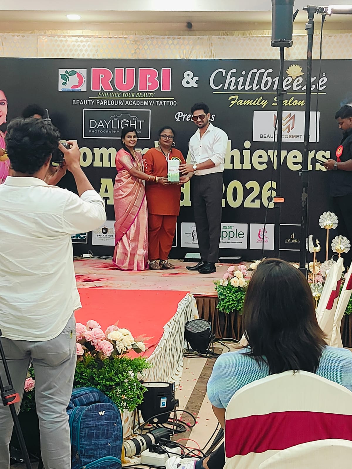 Stage presentation image showing PRIIS product recognition during event program